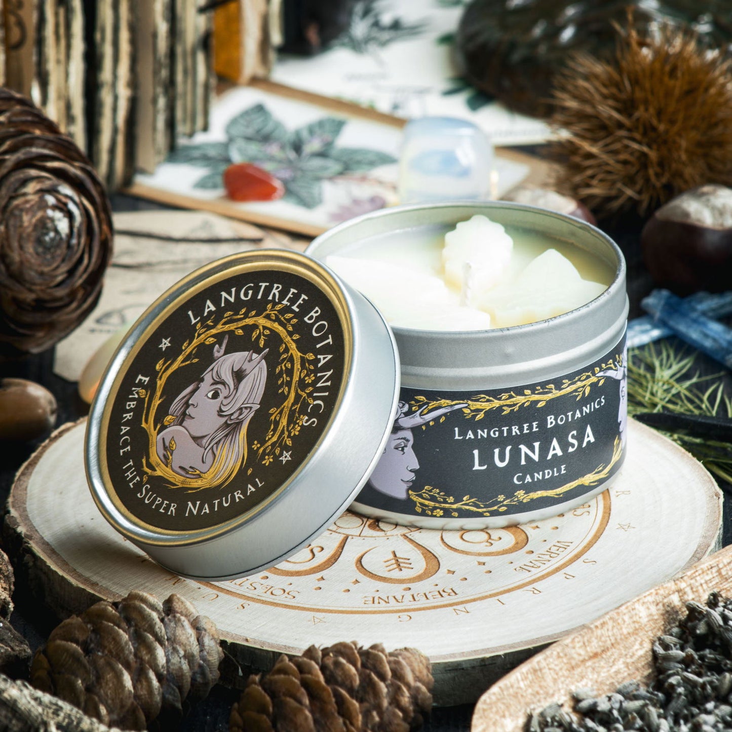 Tin with a lid to one side reveals small wax leaves embedded into the Lunasa rapeseed wax candle from Langtree Botanics