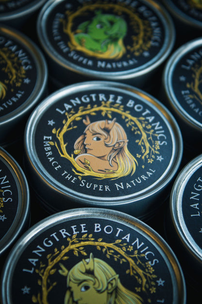 Looking down onto a row of candle tins featuring the Langtree Botanics logo