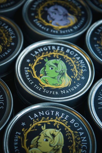 Looking down onto a row of candle tins featuring the Langtree Botanics logo